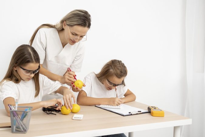 girls-doing-science-experiments-with-female-teacher